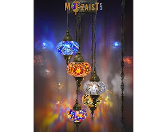 May include: A five-light chandelier with colorful mosaic glass globes. The globes are in shades of blue, red, orange, and white. The chandelier is made of metal and has a chain.