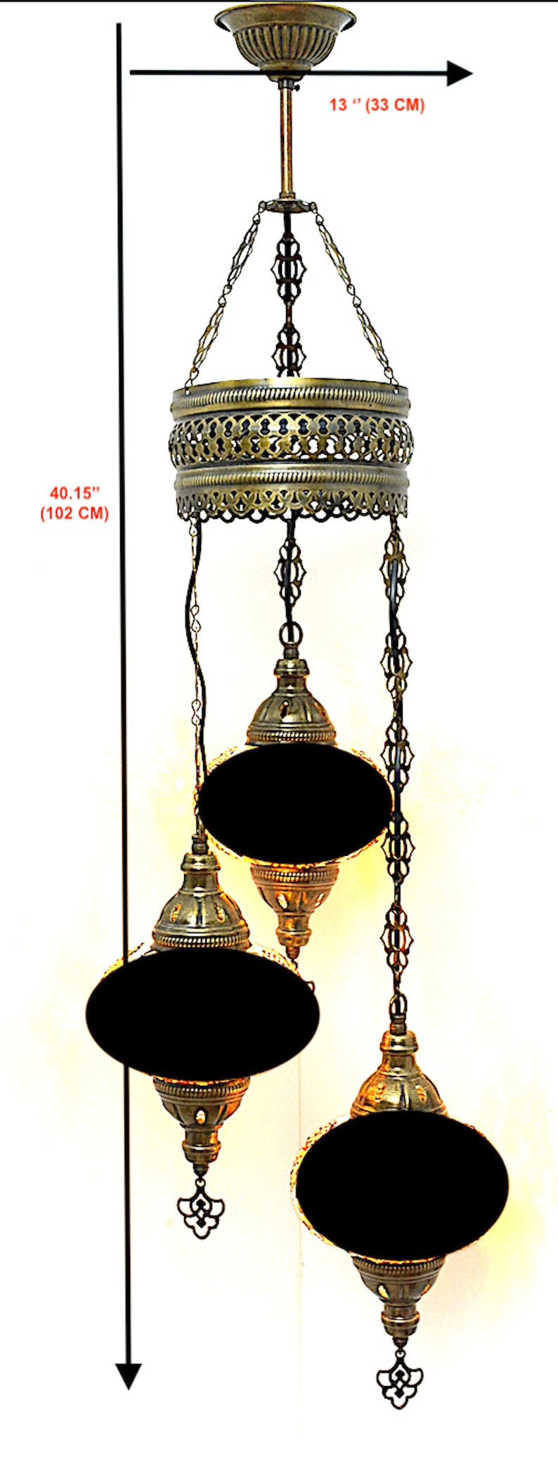 May include: A three-tiered brass chandelier with black glass shades. The chandelier is 40.15 inches (102 cm) tall and has a 13 inch (33 cm) diameter.
