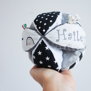 Black and white baby gripping Montessori ball