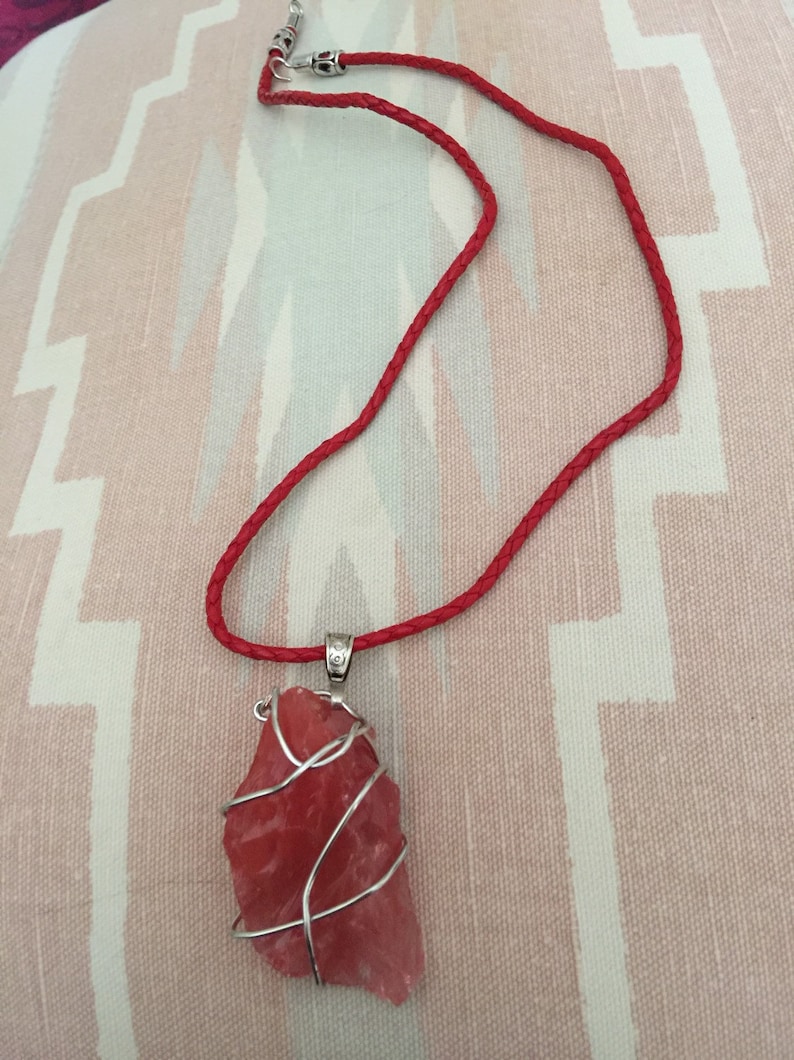 Strawberry Red Andara with a braided red leather necklace.