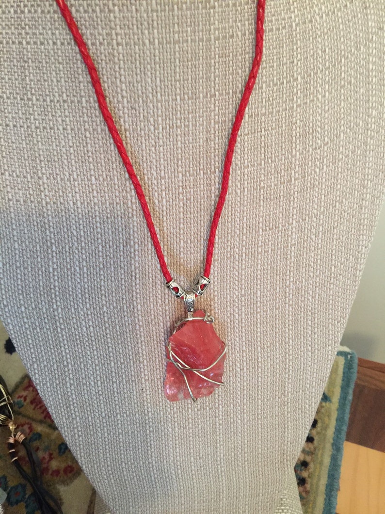 Strawberry Red Andara with a braided red leather necklace.