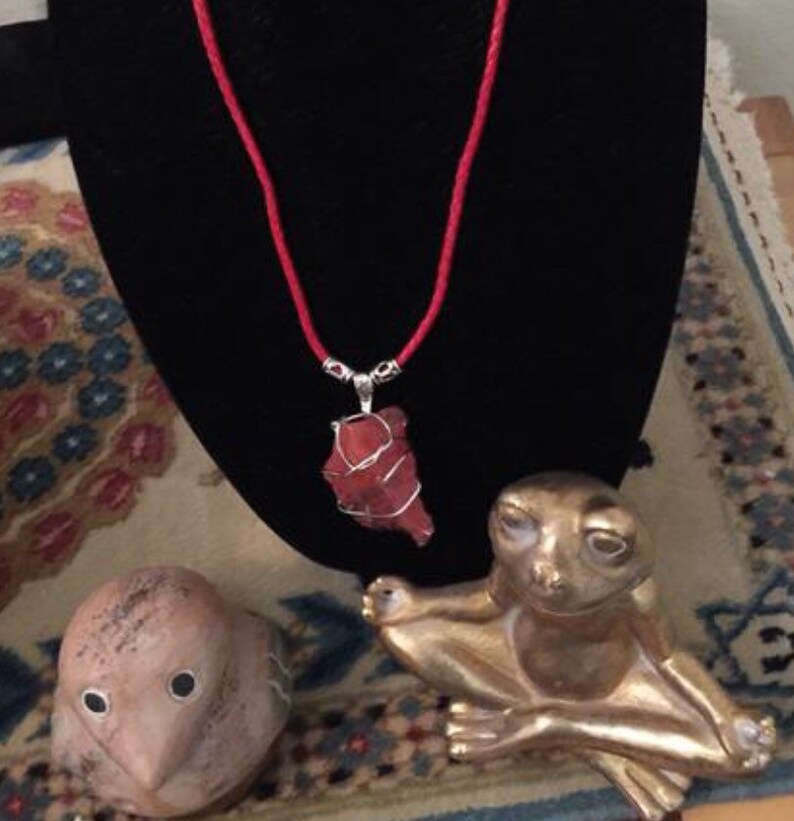 Strawberry Red Andara with a braided red leather necklace.
