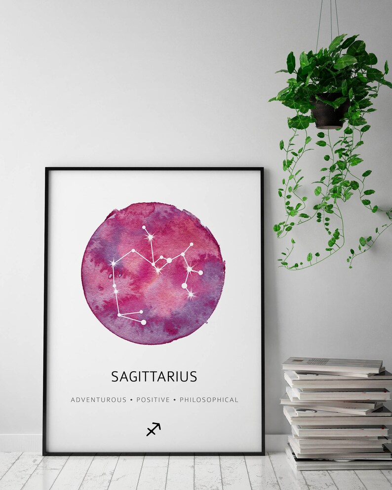 May include: A watercolor print of the Sagittarius constellation in a circle with a pink and purple background. The text "Sagittarius" is below the circle, and the text "Adventurous - Positive - Philosophical" is below that. The Sagittarius symbol is below the text.