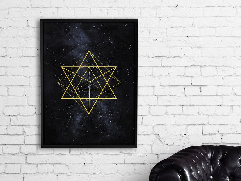 Op de afbeelding: Een zwart ingelijst print met een gouden geometrisch ontwerp op een donkerblauwe achtergrond met witte sterren. Het ontwerp is een stervorm met meerdere overlappende lijnen.