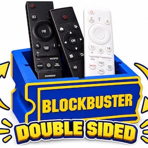 May include: A blue and yellow storage bin shaped like a ticket, featuring the text BLOCKBUSTER and DOUBLE SIDED. The bin holds three remote controls: two black ones and one white one. Two yellow arrows curve around the sides of the container.