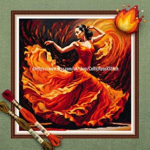 May include: A framed cross-stitch artwork depicts a woman in a flowing red dress dancing. The background is a swirl of orange and black. The artwork is framed in a brown wooden frame. The text "https://www.etsy.com/uk/shop/CelticRoseXStitch" is visible.