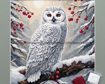 May include: A cross stitch pattern featuring a snowy owl perched on a branch with red berries in a winter landscape. The text PDF Digital Download Cross Stitch Pattern is at the top, and the URL https://www.etsy.com/uk/shop/CelticRoseXStitch is visible.