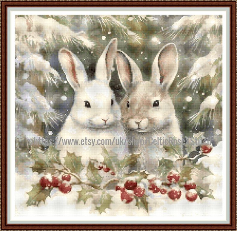 May include: Cross-stitch image of two rabbits in a winter scene. One rabbit is white, the other is tan. Holly with red berries frames the bottom, with a snowy evergreen background. A festive, seasonal design.