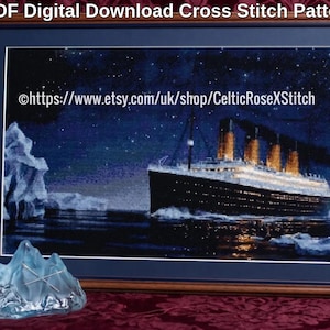 May include: A framed cross stitch pattern titled PDF Digital Download Cross Stitch Pattern featuring the Titanic ship at night near an iceberg under a starry sky, with the text https://www.etsy.com/uk/shop/CelticRoseXStitch visible.
