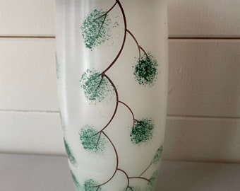 Glass vase with green flowers/green base/gold rimmed /white background