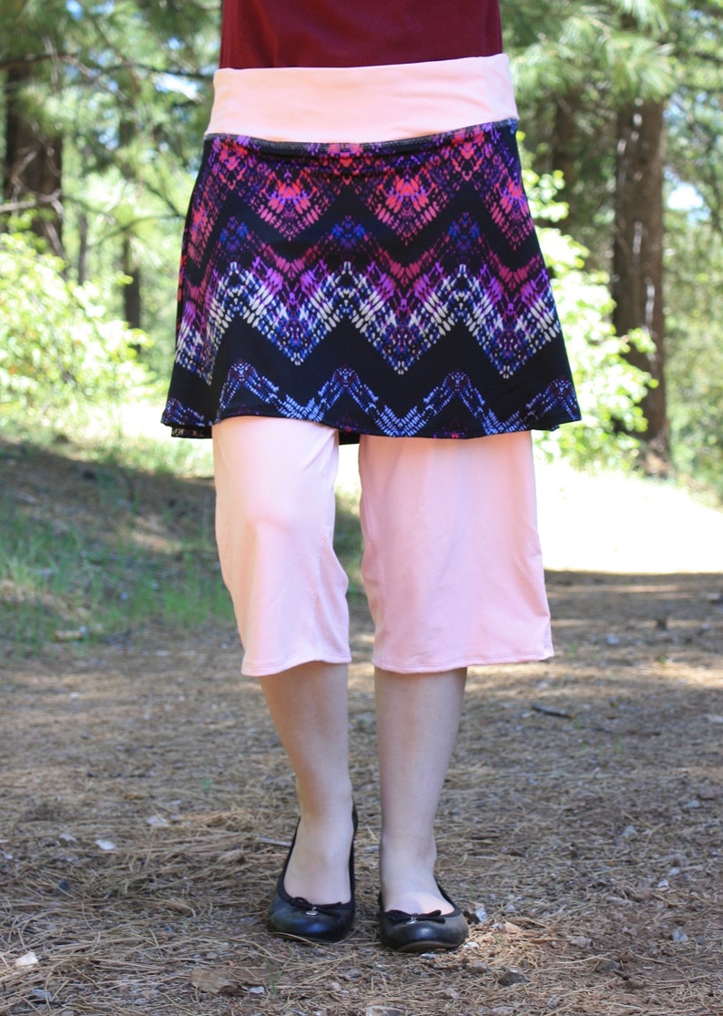 Front view showing diamond/triangular pattern in skirt fabric.  The leggings are slightly loose, and reach a little past the model's knees.