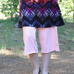 Shown with shirt untucked.  Depending on choice of blouse, the top and skirt can look like a short dress with leggings underneath.