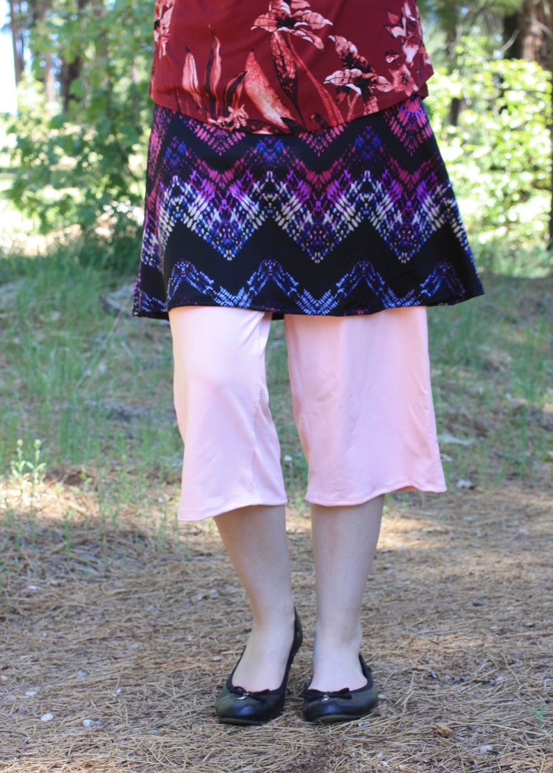 Shown with shirt untucked.  Depending on choice of blouse, the top and skirt can look like a short dress with leggings underneath.