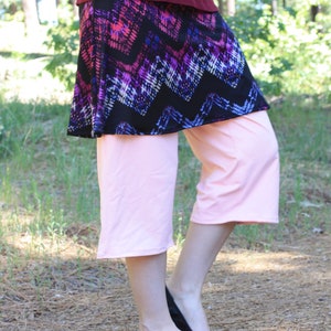 Side view showing the movement of the fabric as the model bends one leg.  The fabrics are soft and stretchy, very comfortable.