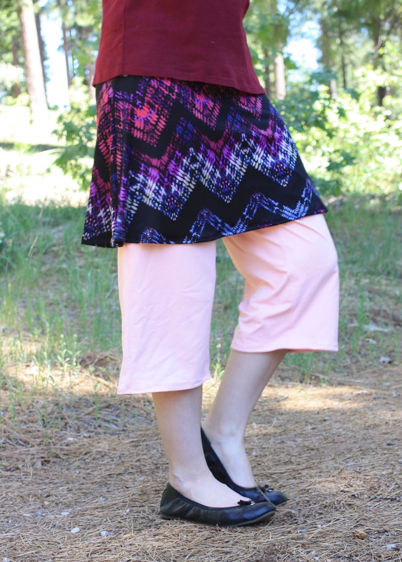 Side view showing the movement of the fabric as the model bends one leg.  The fabrics are soft and stretchy, very comfortable.