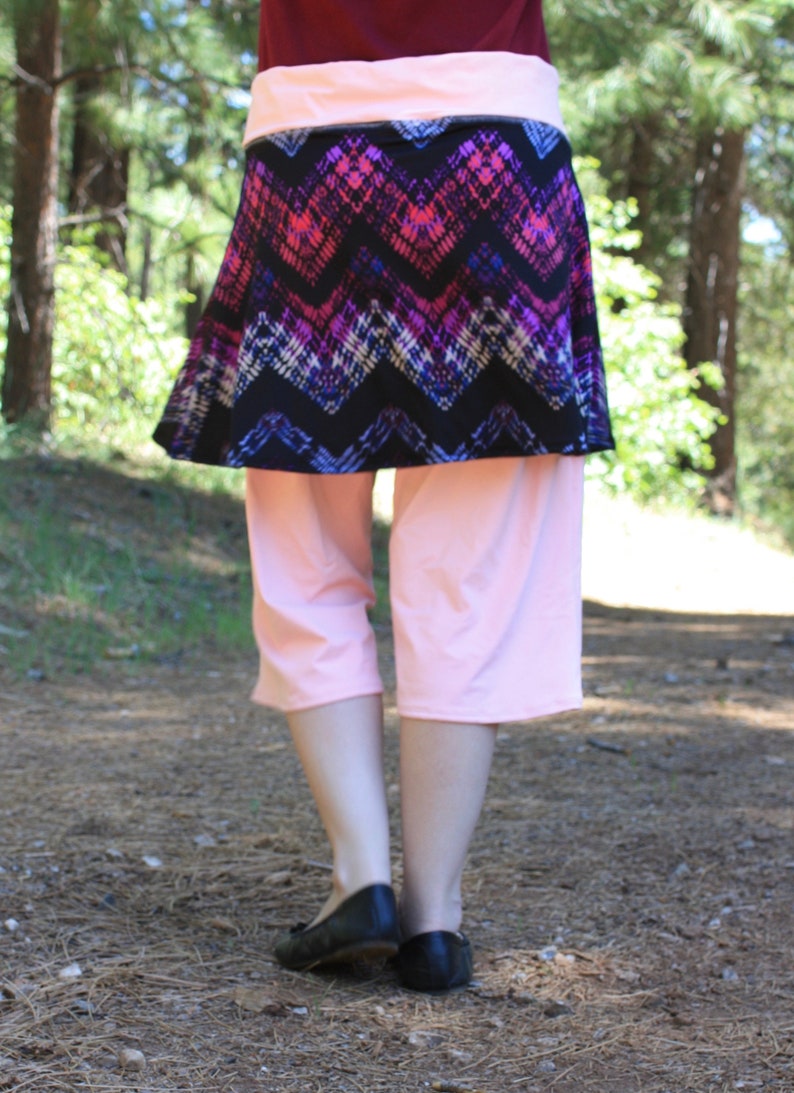 Back view showing the waistband, skirt, and leggings.  The skirt reaches just above the model's knees.