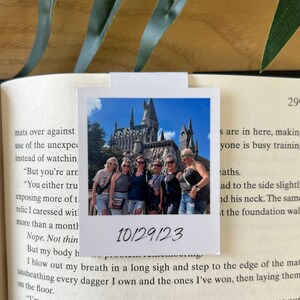 May include: A group of friends pose for a photo in front of Hogwarts castle at Universal Studios. The photo is dated 10/29/23.