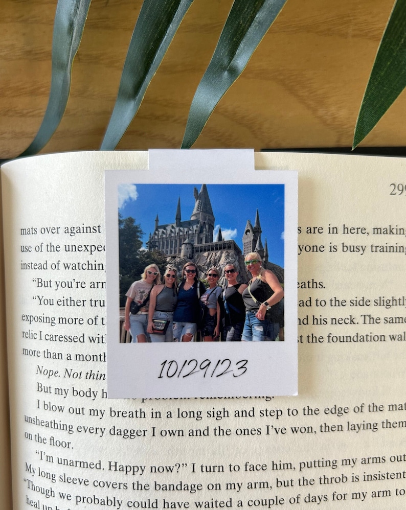 May include: A group of friends pose for a photo in front of Hogwarts castle at Universal Studios. The photo is dated 10/29/23.