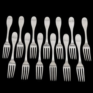 May include: A set of twelve silver forks with ornate handles. The forks are arranged in two rows of six, with the handles pointing upwards.