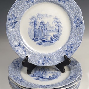 May include: Set of five blue and white porcelain dinner plates with a blue and white floral pattern and a blue and white landscape scene.