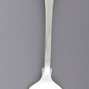 May include: A silver fork with a simple, rounded handle and three prongs.