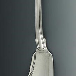 May include: A silver butter knife with a rounded handle and a slightly curved blade.
