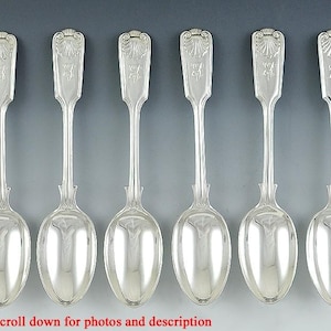May include: Set of six silver spoons with ornate handles. The spoons have a traditional design and are in excellent condition.