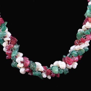 May include: A multi-strand necklace made of green, red, and white beads. The beads are irregularly shaped and appear to be made of natural stone.
