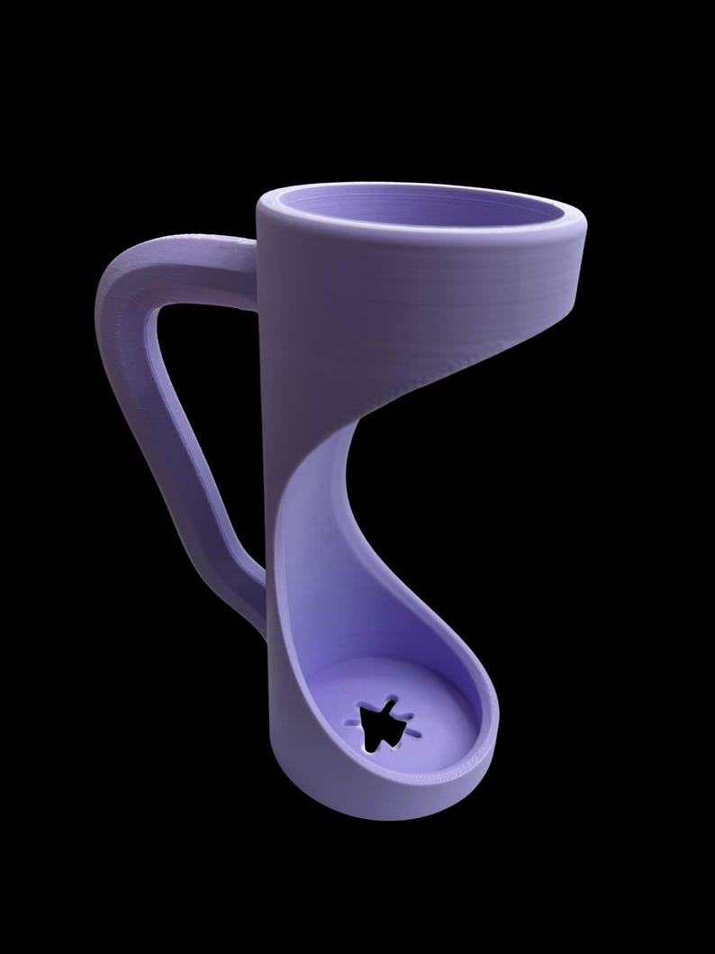May include: A unique, lavender-colored mug with an unconventional design. The mug features a curved handle and a distinctive, open-bottomed structure with a star-shaped cutout. The design is modern and minimalist, set against a black background.