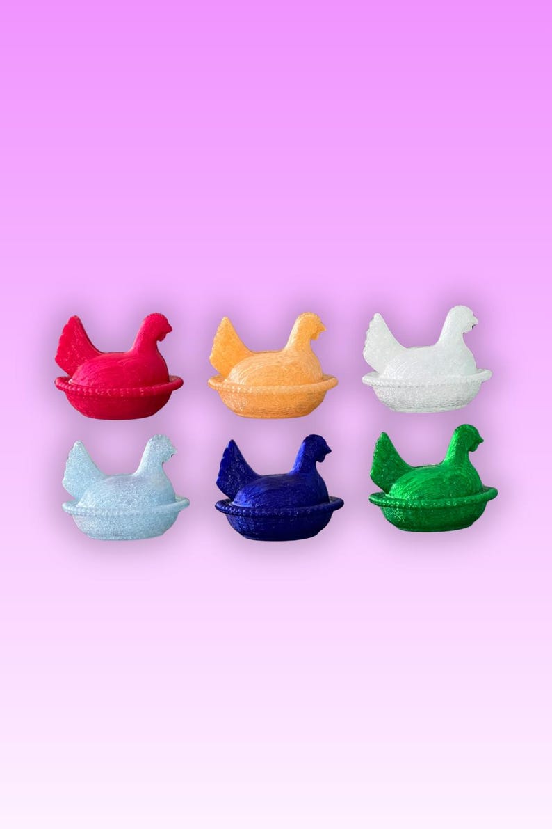 May include: Six brightly coloured hen ornaments in red, orange, white, light blue, dark blue, and green. Each hen sits in a matching nest. The background is a pink to purple gradient.