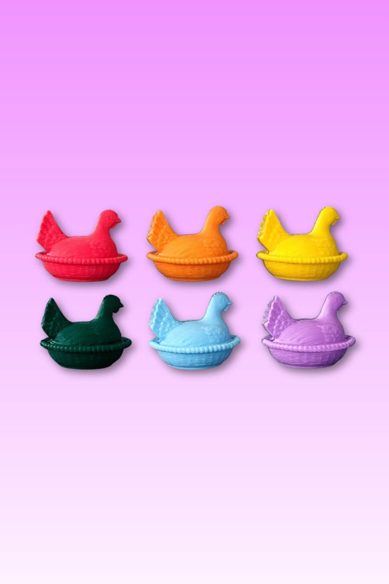 May include: Six brightly coloured hen-shaped containers in red, orange, yellow, green, blue, and purple. Each hen sits in a basket-like base. The background is a pink to purple gradient.