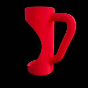 May include: A vibrant red mug with a unique, curved design. The mug features a distinctive handle and a flared base, set against a stark black background. The overall shape is modern and minimalist.