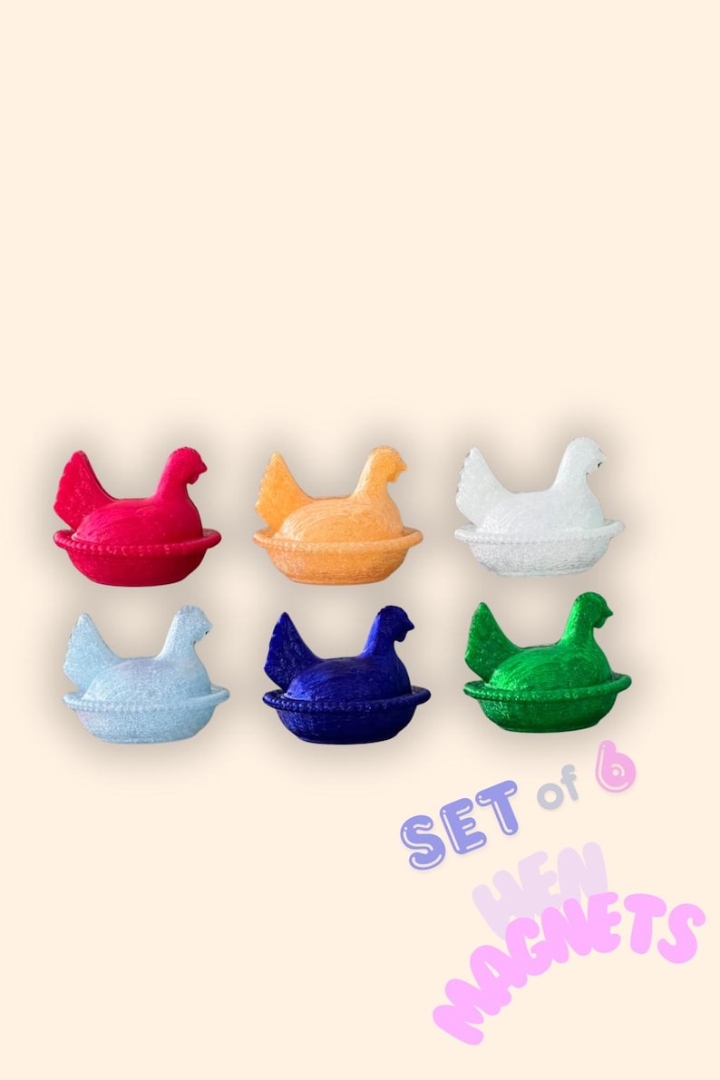 May include: A set of six hen magnets in red, orange, white, light blue, dark blue, and green. Each hen is in a nest-shaped base. The image includes the text "SET of 6 HEN MAGNETS".