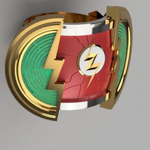 Könnte beinhalten: Ein goldener Ring mit einem roten und weißen Blitz-Design. Der Ring ist offen und hat ein grünes und goldenes Design auf der Innenseite.