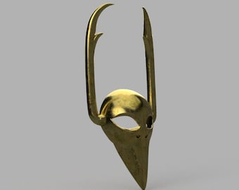 May include: A gold-colored mask with two long, pointed horns. The mask has a pointed chin and a small eye hole.