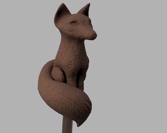 May include: A brown ceramic fox figurine with a curled tail, sitting on a wooden base.
