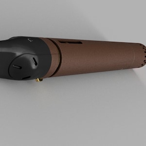 May include: A brown and black handheld torch with a nozzle and a trigger. The torch has a textured brown body and a black handle.