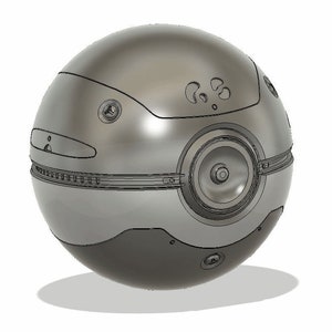 May include: A silver and black sphere with a circular design and multiple small holes. The sphere has a textured surface and a raised band around the middle.