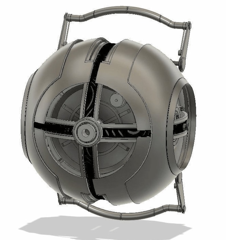 May include: A silver-colored, spherical, mechanical device with a handle and a series of gears and cogs visible through the open sections. The device appears to be a model or prototype.