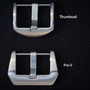 May include: Two brushed metal watch buckles, one labeled "Thumbnail" and the other "Pre-V", are displayed against a textured black background. The buckles have a rectangular shape with a central bar and a pin for securing a watch strap.