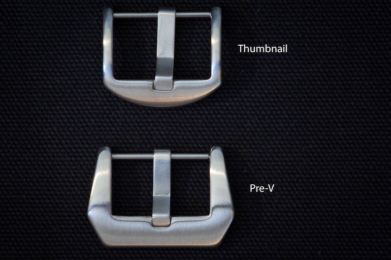 May include: Two brushed metal watch buckles, one labeled "Thumbnail" and the other "Pre-V", are displayed against a textured black background. The buckles have a rectangular shape with a central bar and a pin for securing a watch strap.