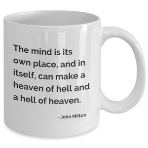 May include: White ceramic mug with a curved handle. The mug features the quote "The mind is its own place, and in itself, can make a heaven of hell and a hell of heaven." attributed to John Milton, printed in black.