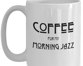 May include: White ceramic coffee mug with black text that reads "COFFEE FOR MY MORNING JAZZ".