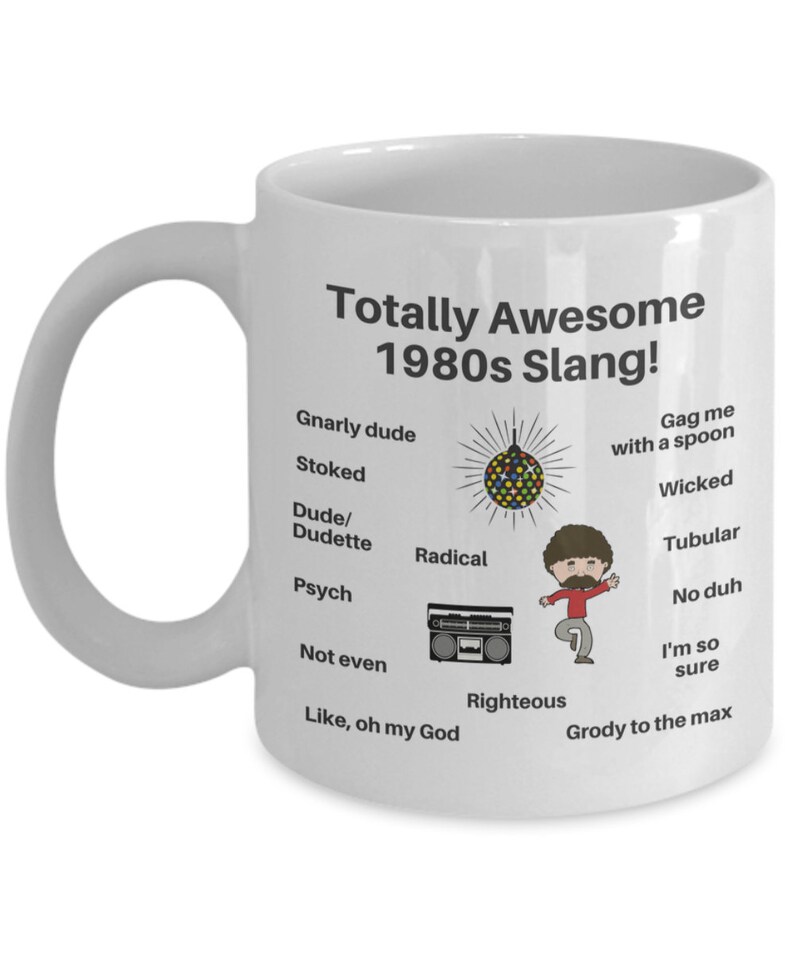 May include: White ceramic coffee mug with a black design featuring 1980s slang terms and illustrations, including a disco ball, a boombox, and a person with a big afro.