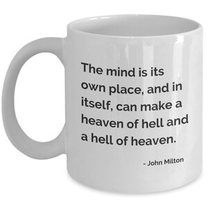 May include: White ceramic mug with a curved handle. The mug features black text that reads: "The mind is its own place, and in itself, can make a heaven of hell and a hell of heaven." The quote is attributed to John Milton.