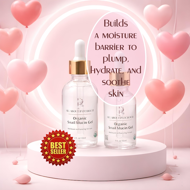 May include: Two clear glass bottles of Organic Snail Mucin Gel serum with white droppers and gold accents. The bottles are on a white pedestal with a "Best Seller" sticker. Pink heart-shaped balloons float in the background.