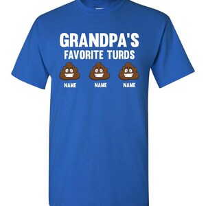 May include: A royal blue t-shirt with the text "Grandpa's Favorite Turds" in white. Three brown cartoon poop emojis with smiling faces are below the text, each with the word "NAME" underneath.