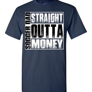 May include: Navy blue t-shirt with a white graphic that says "Soccer Dad Straight Outta Money".