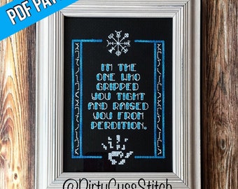 May include: Cross-stitch pattern with a black background and blue and white embroidery. The pattern features a quote: "I'm the one who gripped you tight and raised you from perdition." and a symbol above the quote. The pattern is framed in a silver frame and the text "@DirtyCussStitch" is below the pattern.