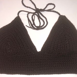 May include: A brown crocheted halter top with a v-neckline.